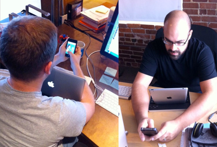 men hugging laptops